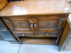 A carved oak 2 drawer 2 cupboard small buffet, height 80cm, width 84cm approx.