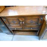 A carved oak 2 drawer 2 cupboard small buffet, height 80cm, width 84cm approx.