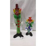 A tall multi coloured glass clown and a smaller example in the style of Murano,