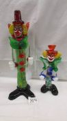 A tall multi coloured glass clown and a smaller example in the style of Murano,