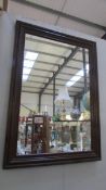 A dark wood framed mirror.