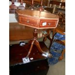 A leather topped octagon drum table on 4 reeded legs, 8 drawers, 4 of which are fake,