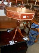 A leather topped octagon drum table on 4 reeded legs, 8 drawers, 4 of which are fake,