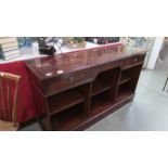 A dark wood stained sideboard with 2 drawers and open front.