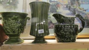 A green pottery jug, jardiniere and vase.