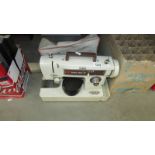 A Frister Star sewing machine with pedal and cover (cover needs a clean).