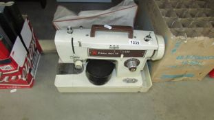 A Frister Star sewing machine with pedal and cover (cover needs a clean).