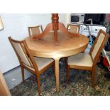 An oak finished round/oval extending dining table with 4 chairs (staining to fabric,