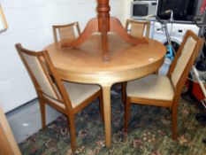 An oak finished round/oval extending dining table with 4 chairs (staining to fabric,