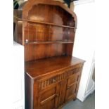 A solid oak arch top cottage dresser with drape carved front, height 182cm, width 112cm approx.
