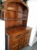 A solid oak arch top cottage dresser with drape carved front, height 182cm, width 112cm approx.