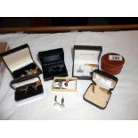 A quantity of cufflinks including a silver set plus a tie pin