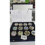 A cased set of 36 gold plated one dollar coins from The History of Space Exploration series with