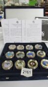 A cased set of 36 gold plated one dollar coins from The History of Space Exploration series with