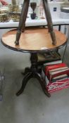 A dark wood stained pub style table with centre column and 4 legs, 60 cm diameter and 68.5 cm tall.