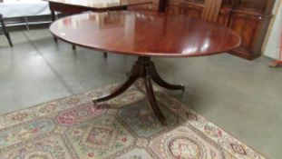 A large circular mahogany dining table, 520 cm (60" diameter).