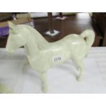 A vintage plastic white horse (possibly advertising).