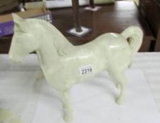 A vintage plastic white horse (possibly advertising).