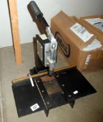 A manual framing press for attaching hangers and rings to picture frame backboards