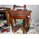 A darkwood nest of tables with green leather inset and glass tops, Height 53.