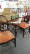 A mahogany extending wind out table with one leaf and a set of 6 chairs.