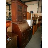 A 1920'30's oak bureau bookcase (lock and escutcheon in drawer and needs to be fixed back on),