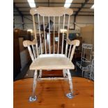 A vintage high stick back Windsor style arm chair