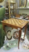 An Italian? inlaid musical games table with chess board top with contents including dominoes,