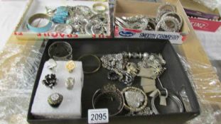 A large selection of silver coloured metal costume jewellery including rings, cuffs, bangles,