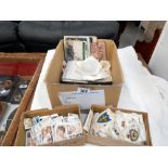 A box of ephemera including vintage postcards and photgraphs,