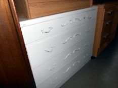 A white painted bedroom chest of drawers with ormolu fittings, height 75cm, width 91cm approx.
