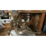 An Austrian art deco female nude figure reading, a/f (repair to ankle).