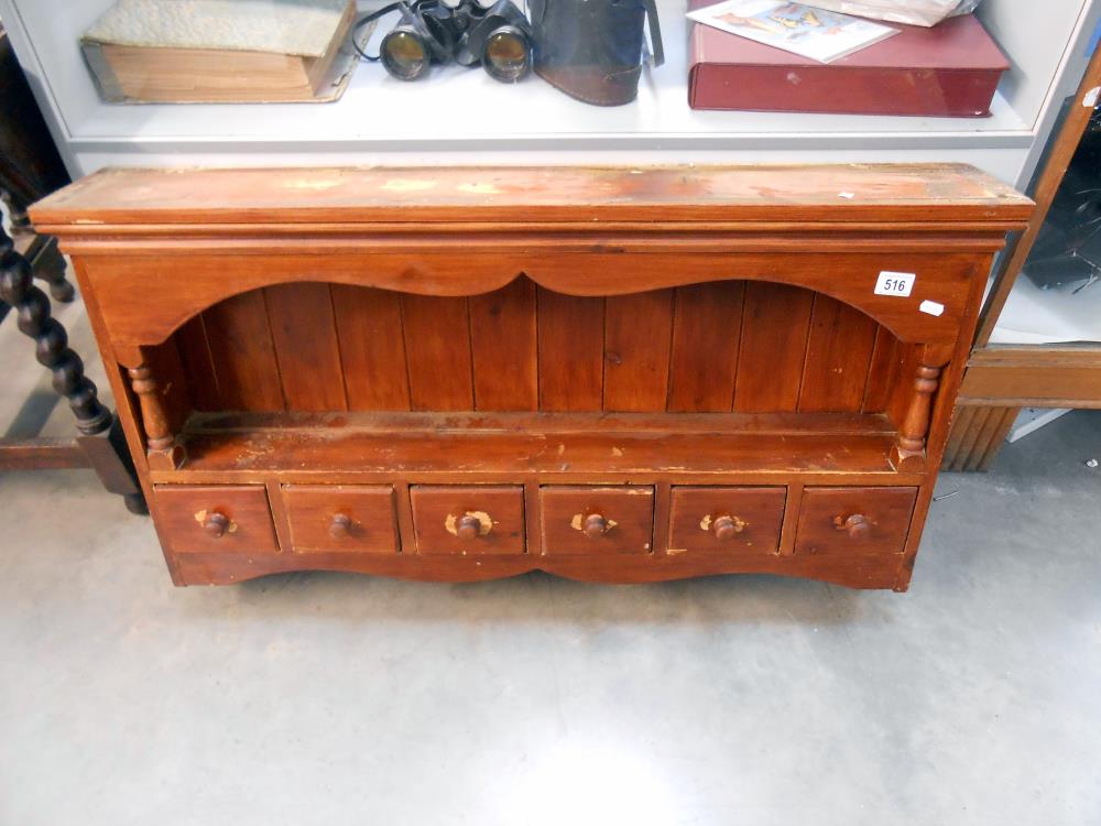 A stained pine kitchen wall shelf unit with drawers, height 57cm at tallest point,