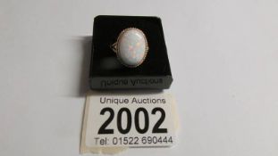 A large oval opal 9ct gold ring size O half, (opal reconstituted).