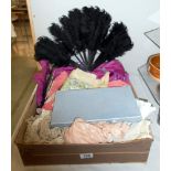 A box of assorted textiles including lace, dresses,