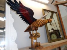 A large wooden figure of an eagle (wings detach as well as base) The bottom has a few minor nibble