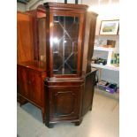 A mahogany corner cupboard with astragal glazed door and cupboard base with 1 key, height 183cm,