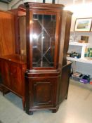 A mahogany corner cupboard with astragal glazed door and cupboard base with 1 key, height 183cm,