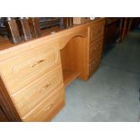 A modern teak effect dressing table, height 79cm, width 137cm approx.