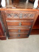 An oak narrow 4 drawer chest of drawers, height 73cm, width 49.5cm approx.