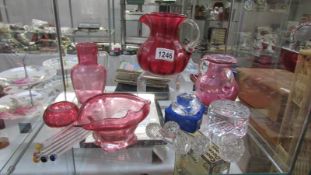 A mixed lot of glass including cranberry glass, cut glass knife rests, paperweights etc.