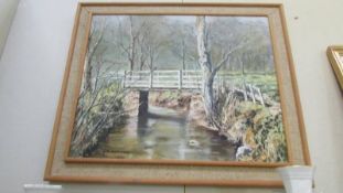 A framed oil on board entitled 'Bridge Over The River Dove, Farndale' signed N Howard 1973.