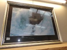 A large framed and glazed print of a lighthouse in rough seas, collect only.