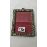A hall marked silver photo frame with bevelled glass, missing back stand.