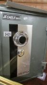 A good 20th century metal safe, made by Eagle, keys and combination with paperwork.