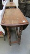 An oak barley twist gate leg table.