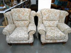 A pair of cream floral pattern lounge chairs
