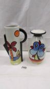 A Lorna Bailey Tropican design jug and a Lorna Bailey Lakeside design vase, both signed.