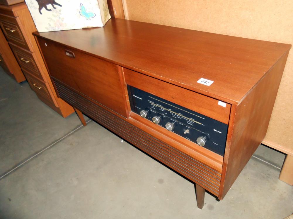 A retro teak effect Westminster record player radio radiogramme, height 66cm, length 117cm approx.
