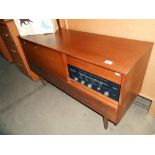A retro teak effect Westminster record player radio radiogramme, height 66cm, length 117cm approx.
